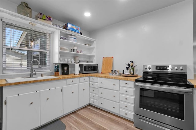 109 Cowan Ave, Fort Cobb, OK 73038 - kitchen featuring stainless steel appliances, light wood finished floors, wood counters, white cabinetry, and recessed lighting