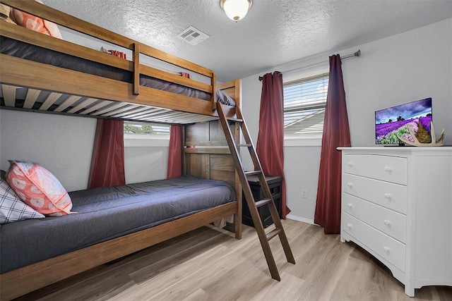 109 Cowan Ave, Fort Cobb, OK 73038 - bedroom with light wood-style floors and a textured ceiling