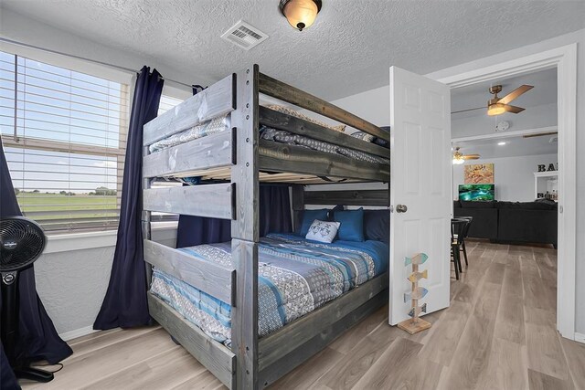 109 Cowan Ave, Fort Cobb, OK 73038 - bedroom featuring wood finished floors and a textured ceiling