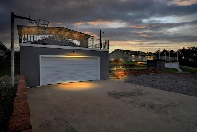 109 Cowan Ave, Fort Cobb, OK 73038 - view of garage at dusk