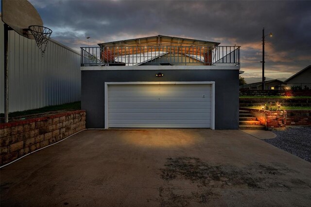 109 Cowan Ave, Fort Cobb, OK 73038 - view of garage at dusk