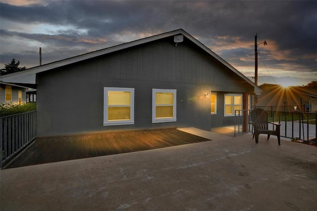 109 Cowan Ave, Fort Cobb, OK 73038 - back of property at dusk featuring a wooden deck