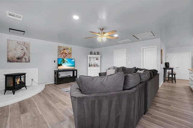 109 Cowan Ave, Fort Cobb, OK 73038 - living area with a wood stove, a ceiling fan, light wood finished floors, and recessed lighting