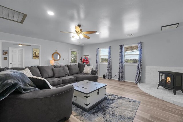 109 Cowan Ave, Fort Cobb, OK 73038 - living area featuring ceiling fan, a wood stove, light wood-type flooring, and recessed lighting