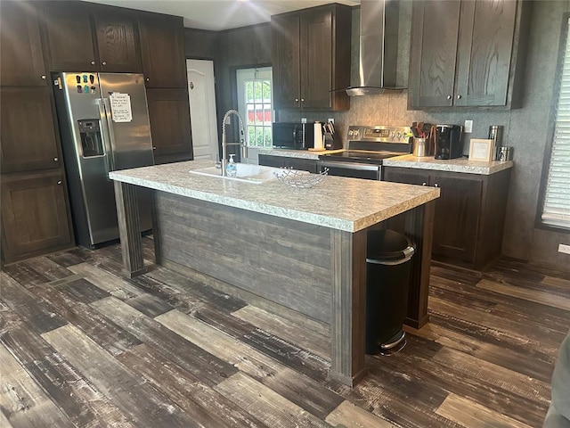 4341 Paradise Rd, Kingston, OK 73429 - kitchen with wall chimney exhaust hood, stainless steel appliances, dark wood-style flooring, a sink, and light countertops