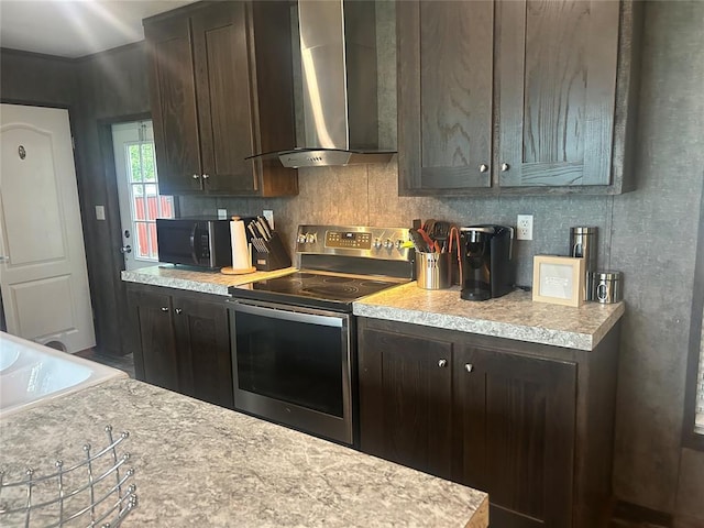 4341 Paradise Rd, Kingston, OK 73429 - kitchen with stainless steel range with electric cooktop, wall chimney exhaust hood, black microwave, and light countertops