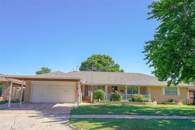 2313 SW 91st St, Oklahoma City, OK 73159 - ranch-style home with an attached garage, brick siding, concrete driveway, a front yard, and covered porch