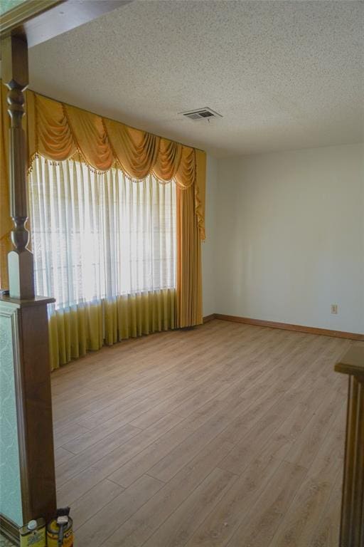 2313 SW 91st St, Oklahoma City, OK 73159 - spare room with a textured ceiling, baseboards, and light wood-type flooring