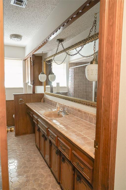 2313 SW 91st St, Oklahoma City, OK 73159 - full bathroom featuring vanity and a textured ceiling