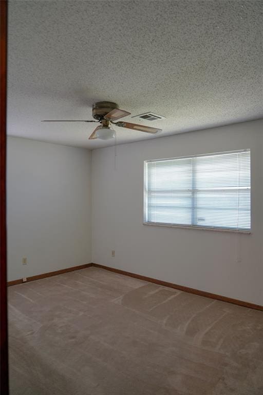 2313 SW 91st St, Oklahoma City, OK 73159 - spare room featuring ceiling fan, light carpet, baseboards, and a textured ceiling