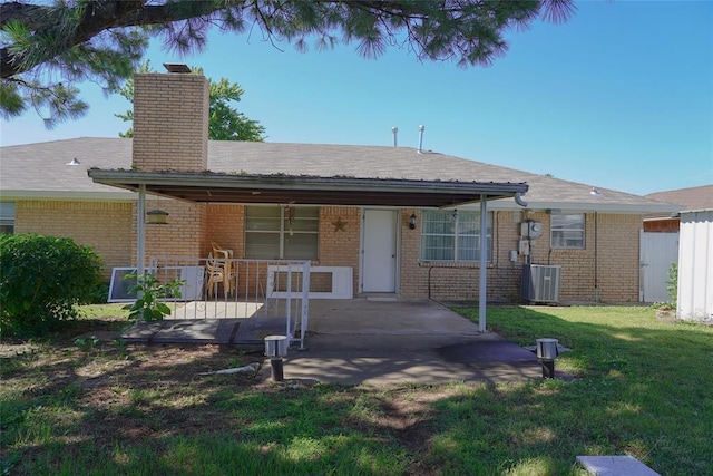 2313 SW 91st St, Oklahoma City, OK 73159 - ranch-style house with a front lawn, brick siding, central AC unit, a chimney, and a patio area