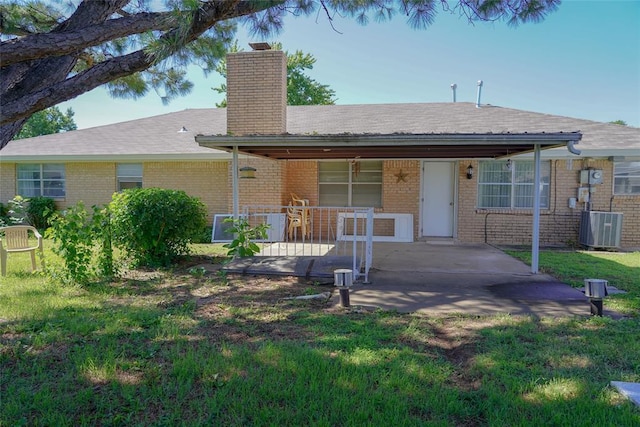 2313 SW 91st St, Oklahoma City, OK 73159 - ranch-style home featuring a chimney, a front lawn, brick siding, cooling unit, and covered porch