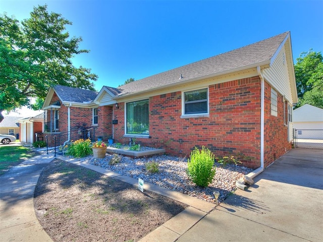 2824 NW 47th St, Oklahoma City, OK 73112 - ranch-style house with brick siding, an outdoor structure, a garage, and a shingled roof