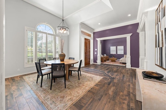 14705 Longford Way, Edmond, OK 73013 - dining space with ornate columns, crown molding, a chandelier, baseboards, and dark wood finished floors