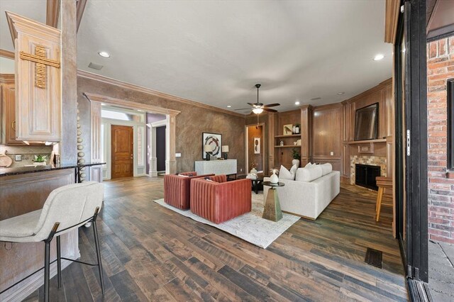 14705 Longford Way, Edmond, OK 73013 - living room with a fireplace, dark wood-style floors, a ceiling fan, recessed lighting, and crown molding