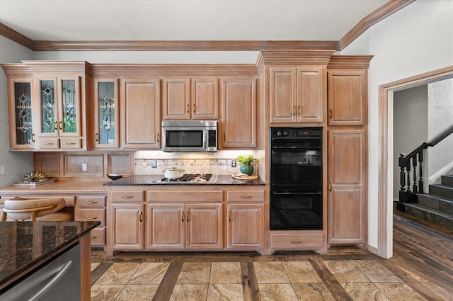 14705 Longford Way, Edmond, OK 73013 - kitchen featuring stainless steel appliances, tasteful backsplash, crown molding, glass insert cabinets, and dark stone counters