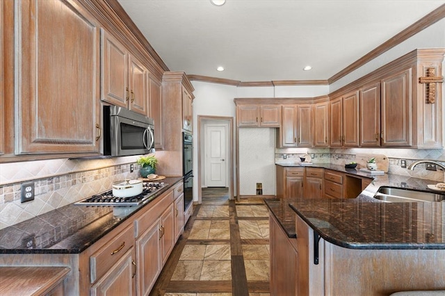 14705 Longford Way, Edmond, OK 73013 - kitchen featuring appliances with stainless steel finishes, a sink, crown molding, dark stone countertops, and decorative backsplash