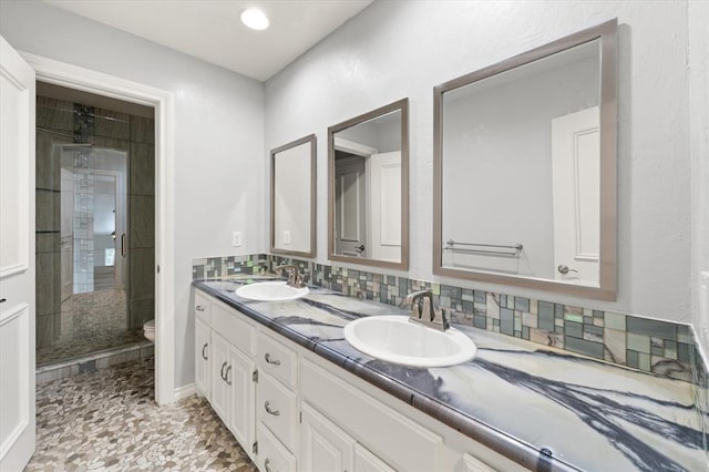 14705 Longford Way, Edmond, OK 73013 - full bathroom featuring double vanity, a stall shower, toilet, and backsplash