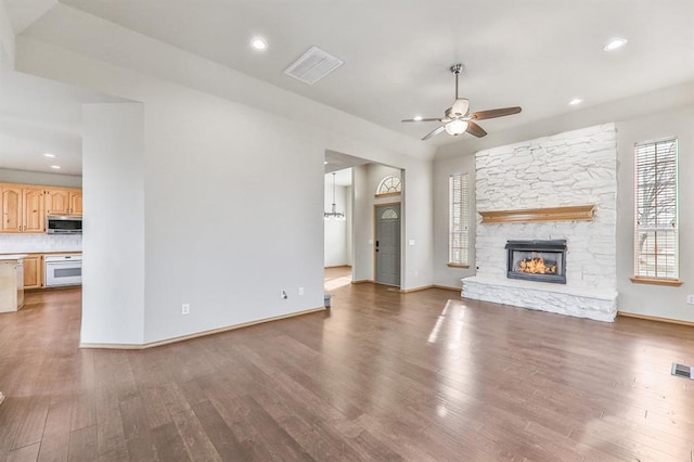 4931 SE 54th St, Oklahoma City, OK 73135 - unfurnished living room with a ceiling fan, wood finished floors, a stone fireplace, and recessed lighting