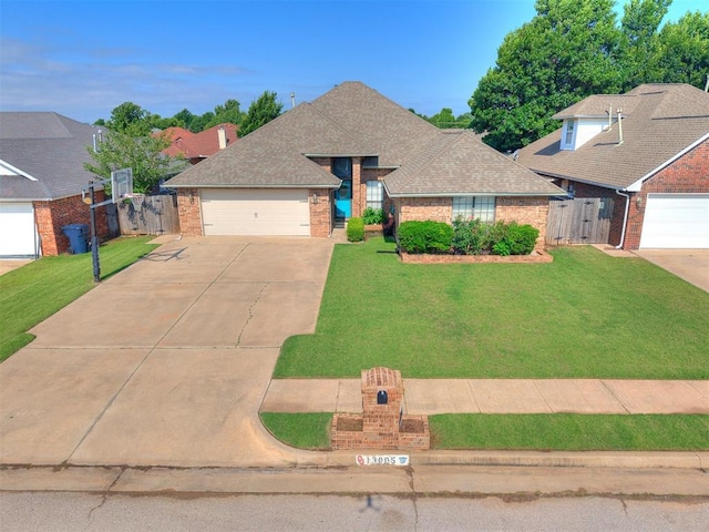 13005 Willowcrest Ln, Oklahoma City, OK 73170 - view of front of home with brick siding, a gate, concrete driveway, a shingled roof, and an attached garage