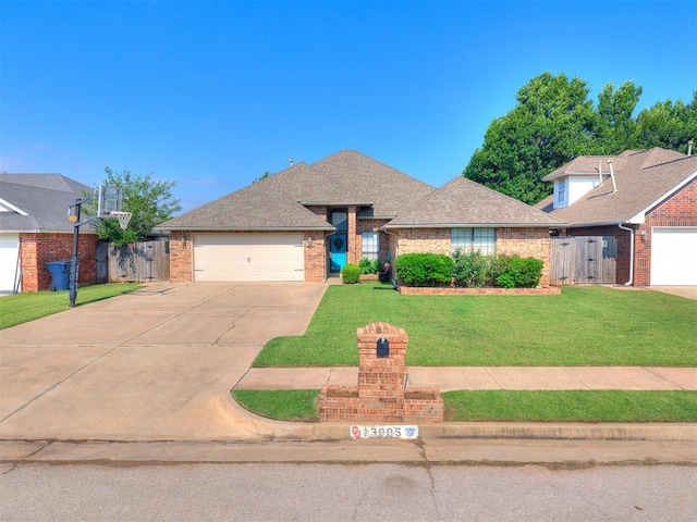 13005 Willowcrest Ln, Oklahoma City, OK 73170 - view of front of home featuring a garage, driveway, brick siding, and a shingled roof