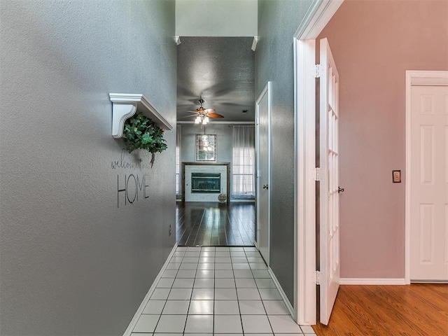 13005 Willowcrest Ln, Oklahoma City, OK 73170 - corridor featuring wood finished floors, baseboards, and a textured wall