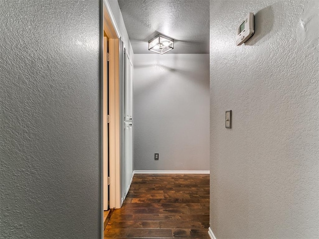 13005 Willowcrest Ln, Oklahoma City, OK 73170 - hallway with hardwood / wood-style floors, a textured ceiling, a textured wall, and baseboards