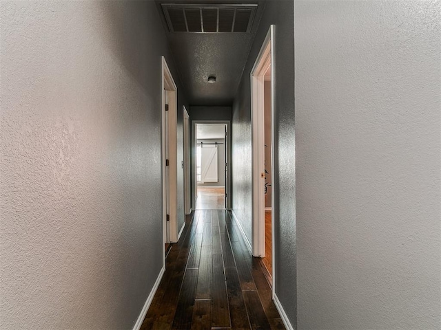 13005 Willowcrest Ln, Oklahoma City, OK 73170 - corridor featuring dark wood-style flooring, baseboards, and a textured wall