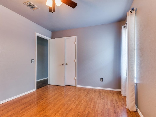 13005 Willowcrest Ln, Oklahoma City, OK 73170 - unfurnished bedroom with light wood-style floors, baseboards, a ceiling fan, and a closet