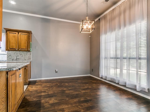 13005 Willowcrest Ln, Oklahoma City, OK 73170 - unfurnished dining area featuring dark wood-style floors, a chandelier, ornamental molding, and baseboards