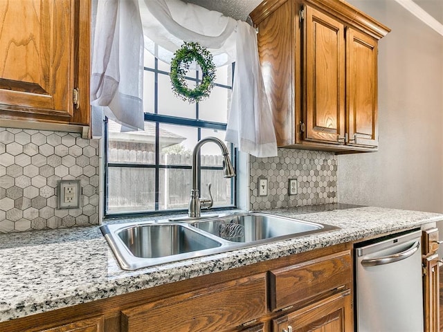 13005 Willowcrest Ln, Oklahoma City, OK 73170 - kitchen featuring a sink, stainless steel dishwasher, backsplash, and brown cabinetry