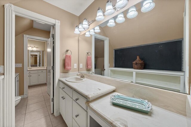 910744 S 3440th Rd, Chandler, OK 74834 - bathroom featuring toilet, two vanities, tile patterned floors, and lofted ceiling