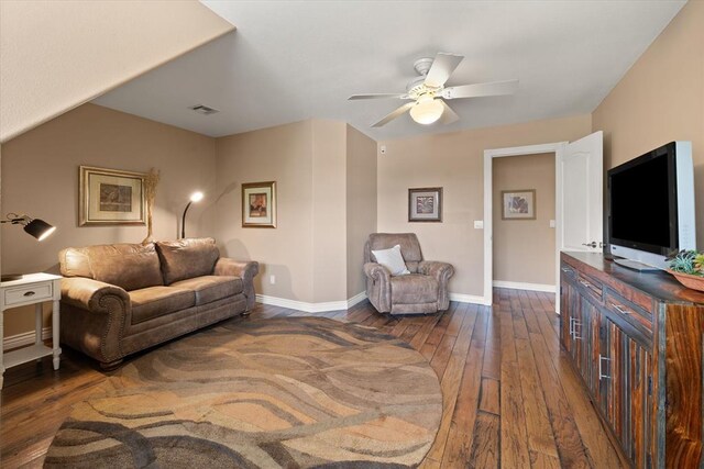 910744 S 3440th Rd, Chandler, OK 74834 - living room featuring dark wood-type flooring, a ceiling fan, and baseboards