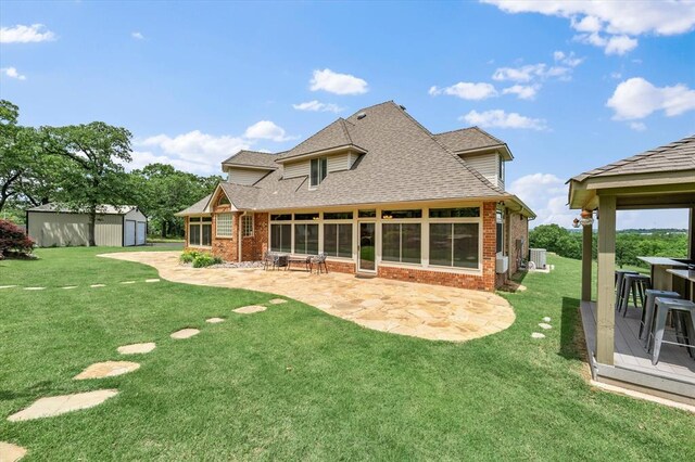 910744 S 3440th Rd, Chandler, OK 74834 - back of house with brick siding, a patio, and a yard