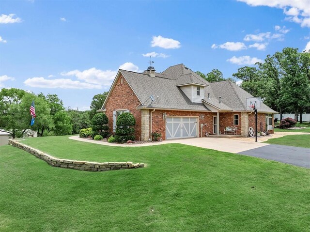 910744 S 3440th Rd, Chandler, OK 74834 - view of property exterior featuring driveway, a lawn, brick siding, and roof with shingles