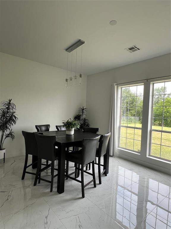 1030 Belmonte Ct, Yukon, OK 73099 - dining space featuring light marble finish flooring