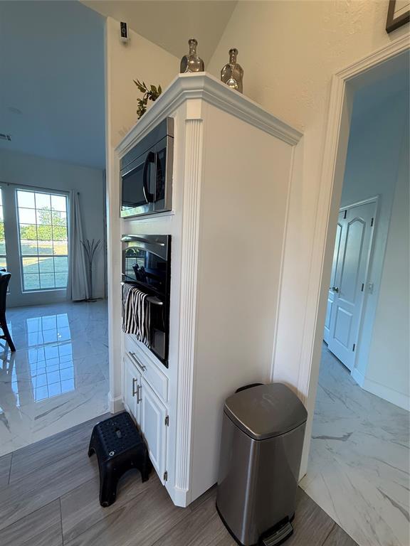 1030 Belmonte Ct, Yukon, OK 73099 - detailed view of stainless steel microwave and baseboards