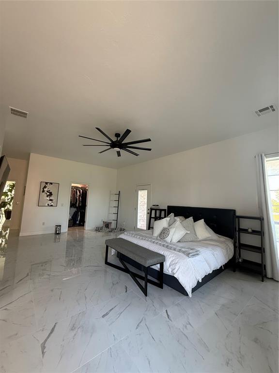 1030 Belmonte Ct, Yukon, OK 73099 - bedroom with ceiling fan, a spacious closet, marble finish floors, and a closet