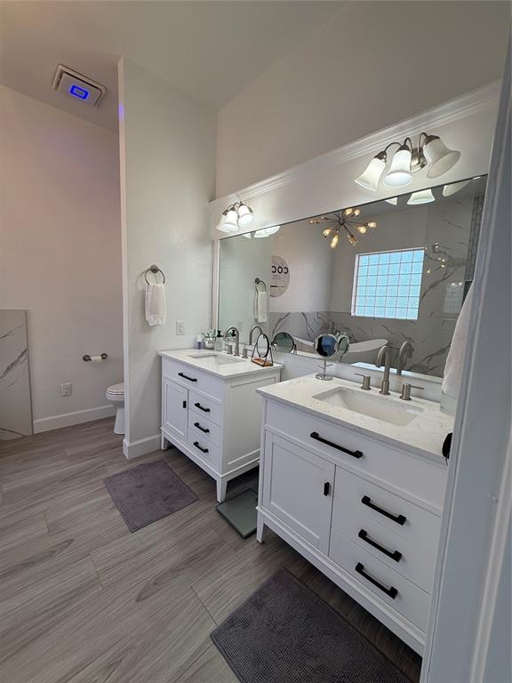 1030 Belmonte Ct, Yukon, OK 73099 - full bathroom with two vanities, toilet, and a shower