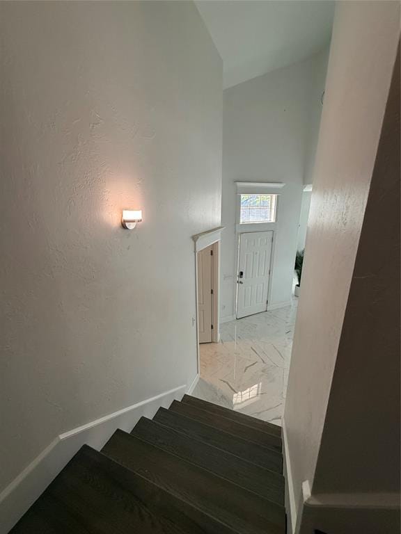 1030 Belmonte Ct, Yukon, OK 73099 - stairs featuring baseboards, high vaulted ceiling, and marble finish flooring