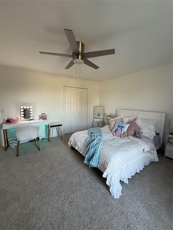 1030 Belmonte Ct, Yukon, OK 73099 - carpeted bedroom featuring a closet, an office area, and a ceiling fan