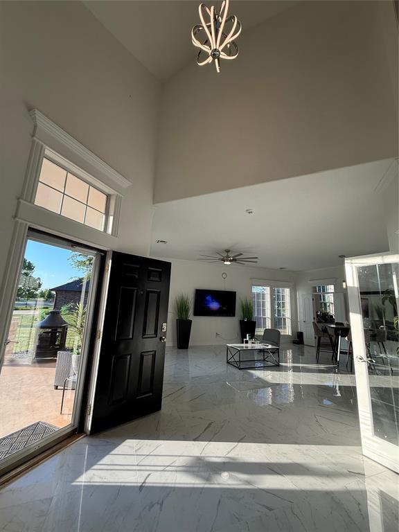 1030 Belmonte Ct, Yukon, OK 73099 - entrance foyer with a towering ceiling, marble tiled floors, and a chandelier