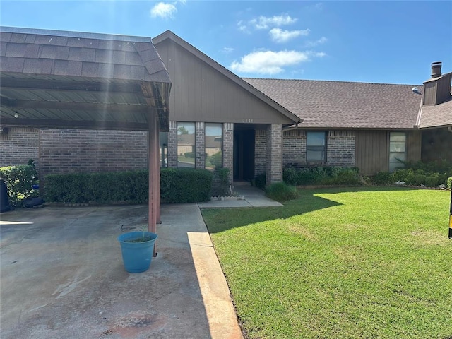 6414 Galaxie Ter, Oklahoma City, OK 73132 - entrance to property featuring brick siding, a yard, roof with shingles, and a chimney