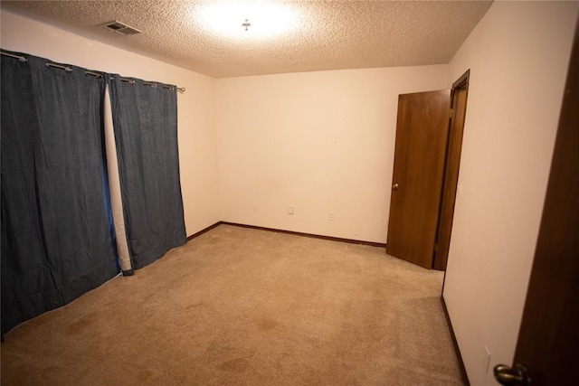 6414 Galaxie Ter, Oklahoma City, OK 73132 - spare room featuring light colored carpet and a textured ceiling