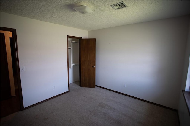 6414 Galaxie Ter, Oklahoma City, OK 73132 - unfurnished bedroom with carpet floors, baseboards, and a textured ceiling