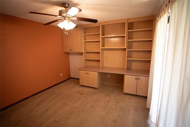 6414 Galaxie Ter, Oklahoma City, OK 73132 - unfurnished office featuring light colored carpet, built in desk, ceiling fan, baseboards, and a textured ceiling