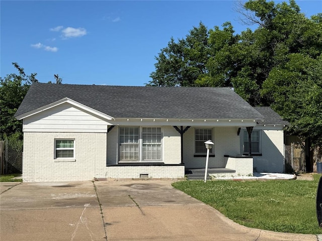 3208 N Roff Ave, Oklahoma City, OK 73112 - view of front facade featuring brick siding, a front yard, and a porch