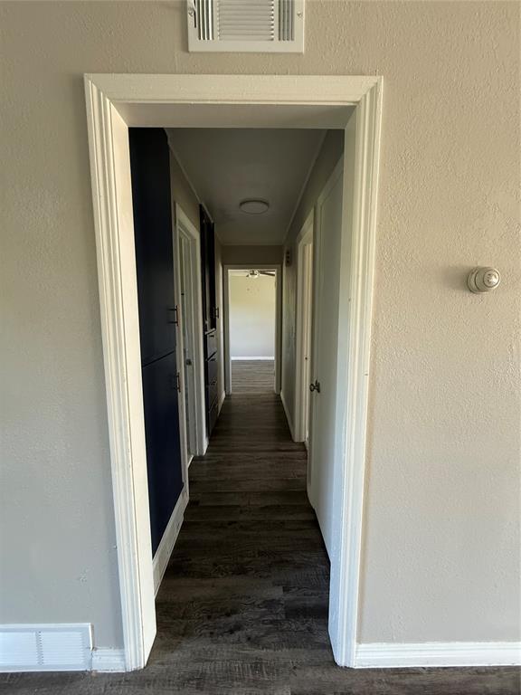3208 N Roff Ave, Oklahoma City, OK 73112 - hallway featuring dark wood-style floors and baseboards