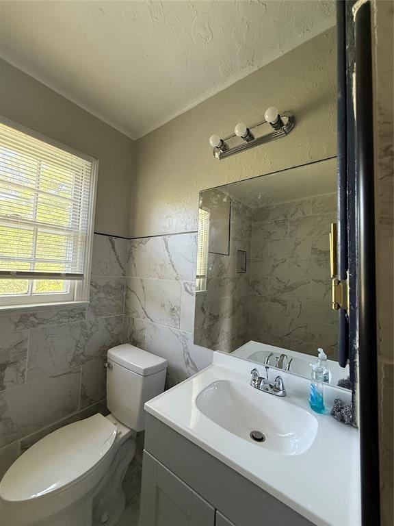 3208 N Roff Ave, Oklahoma City, OK 73112 - bathroom featuring tile walls, vanity, toilet, and marble finish flooring
