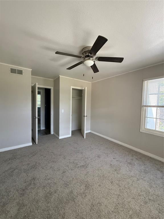 3208 N Roff Ave, Oklahoma City, OK 73112 - unfurnished bedroom with baseboards, a closet, carpet flooring, and a ceiling fan